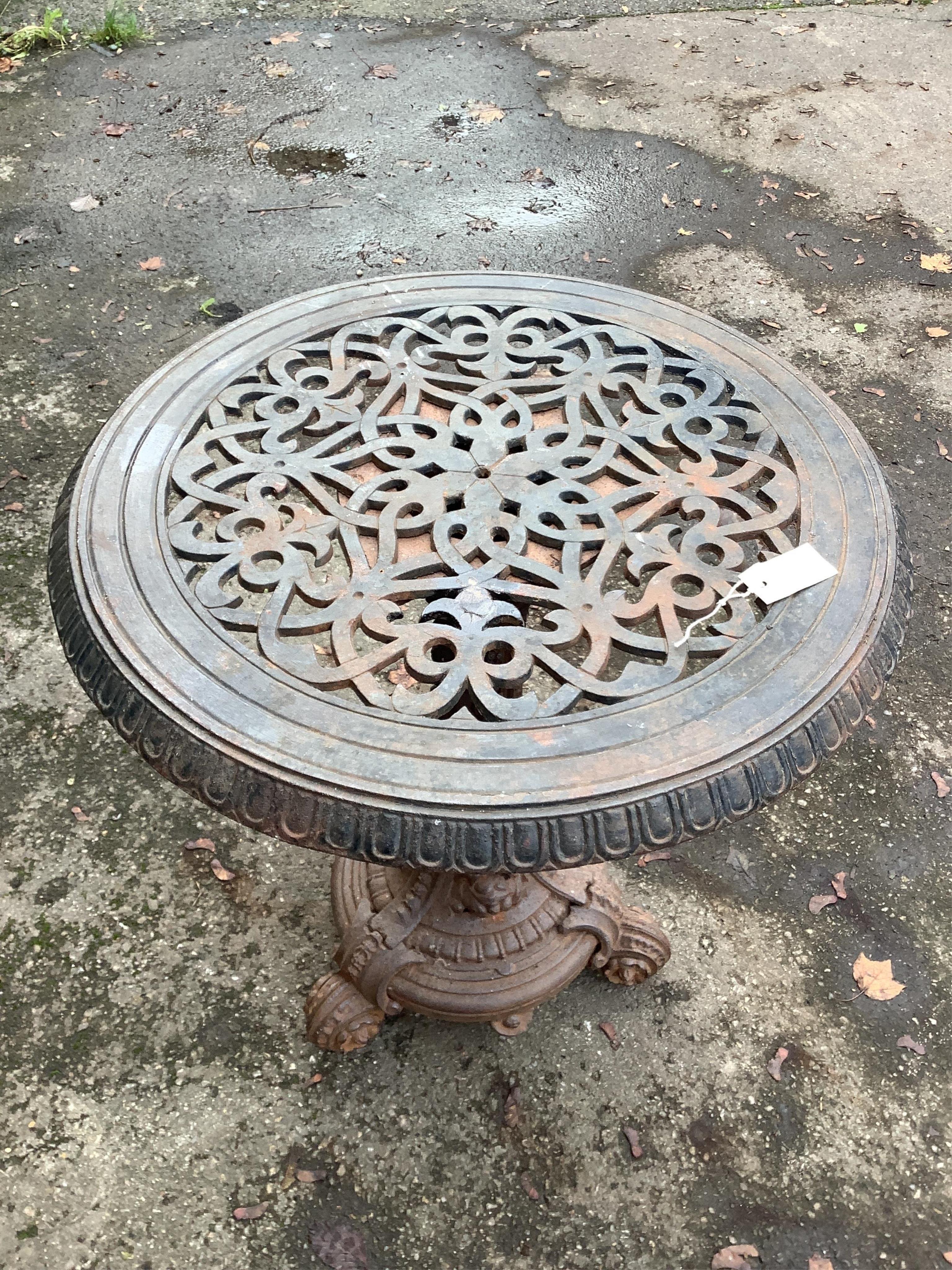 An unusually heavy Victorian cast iron garden table, diameter 70cm, height 72cm. Condition - oxidised, otherwise good